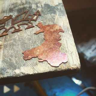 A copper cut out of the map of wales